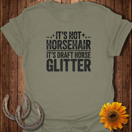 Green t-shirt with "It's not horsehair it's draft horse glitter" text.