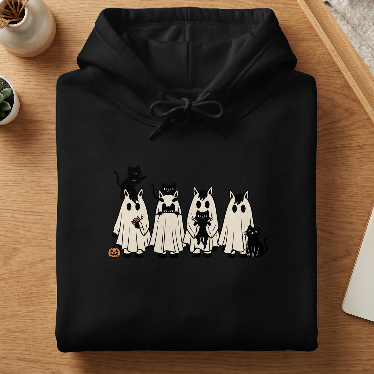 Black hoodie with a Halloween print of cats in ghost costumes and a pumpkin.