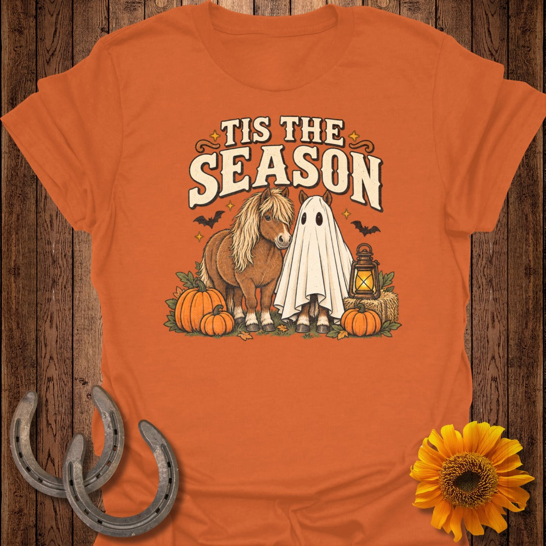 Pony and ghost horses with pumpkins and lantern on orange shirt, "Tis the Season" text.