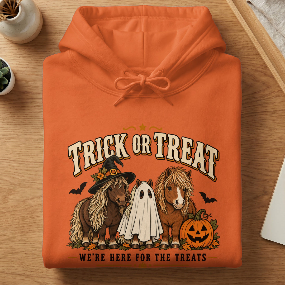 Orange hoodie with "Trick or Treat" text, ponies, ghost, and pumpkin graphic.