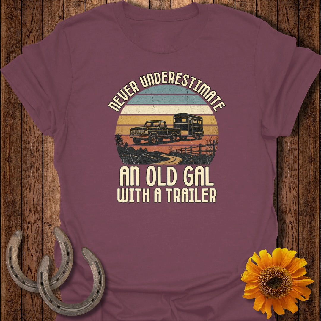 T-shirt with retro truck and trailer graphic, reads "Never Underestimate An Old Gal With A Trailer".
