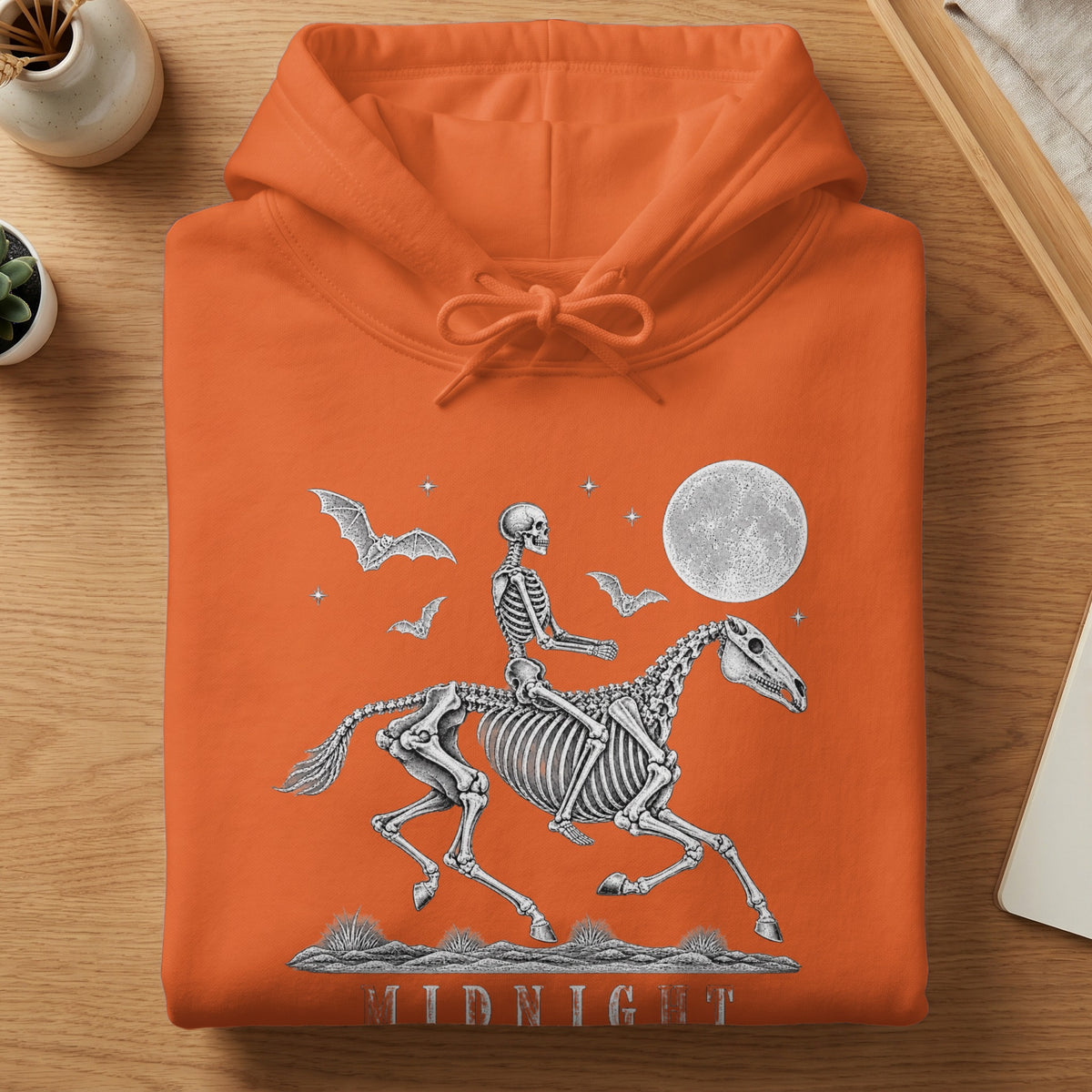Orange hoodie with skeleton rider on a horse, bats, moon, and "MIDNIGHT" text.
