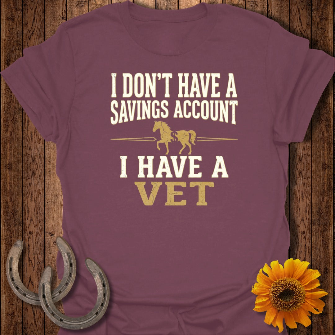 Burgundy t-shirt with white text "I DON'T HAVE A SAVINGS ACCOUNT I HAVE A VET" and horse graphic.