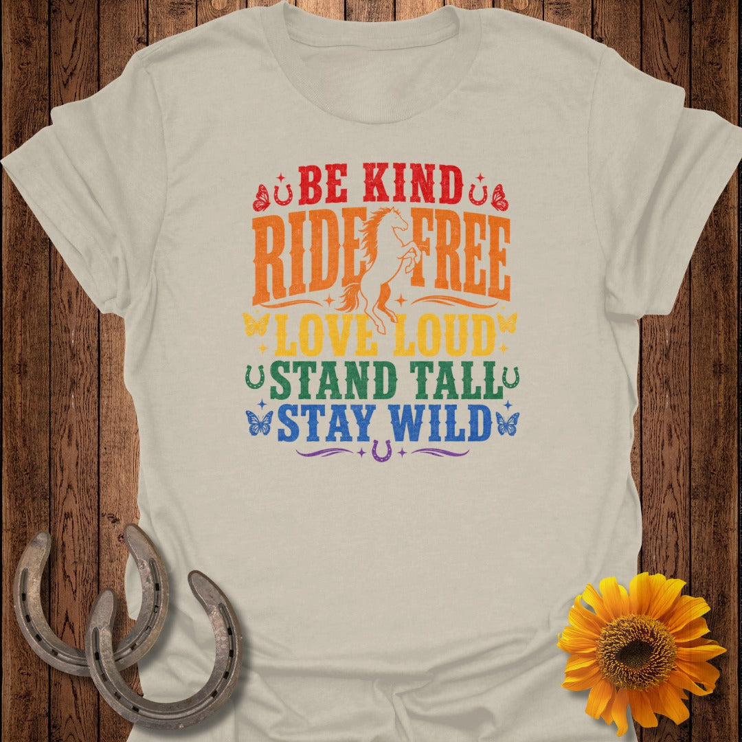 BE KIND, RIDE FREE, LOVE LOUD, STAND TALL, STAY WILD graphic on a beige t-shirt.