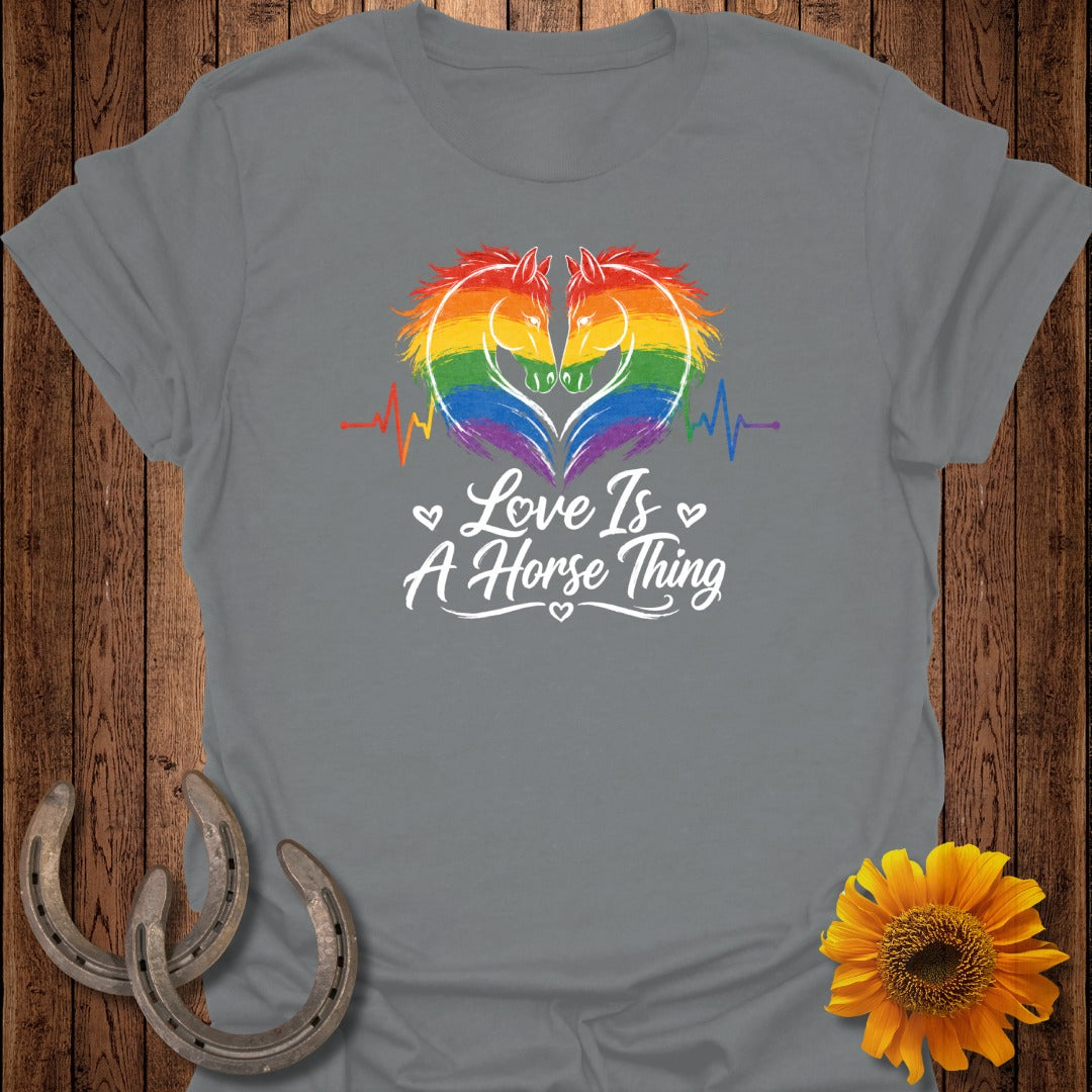 Grey t-shirt with rainbow heart horse design and "Love Is A Horse Thing" text.