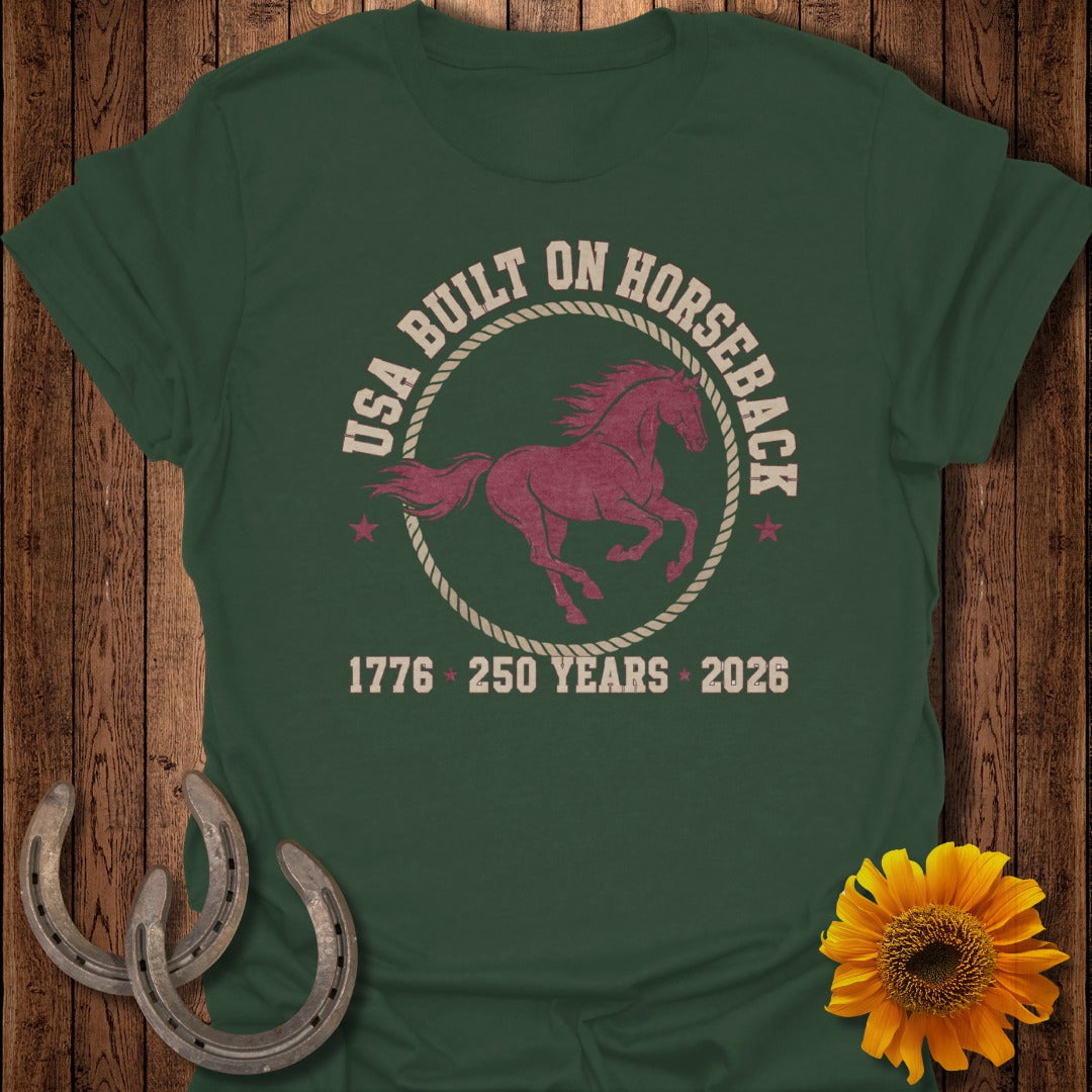 Green t-shirt with "USA Built on Horseback 1776 250 Years 2026" text and horse graphic.