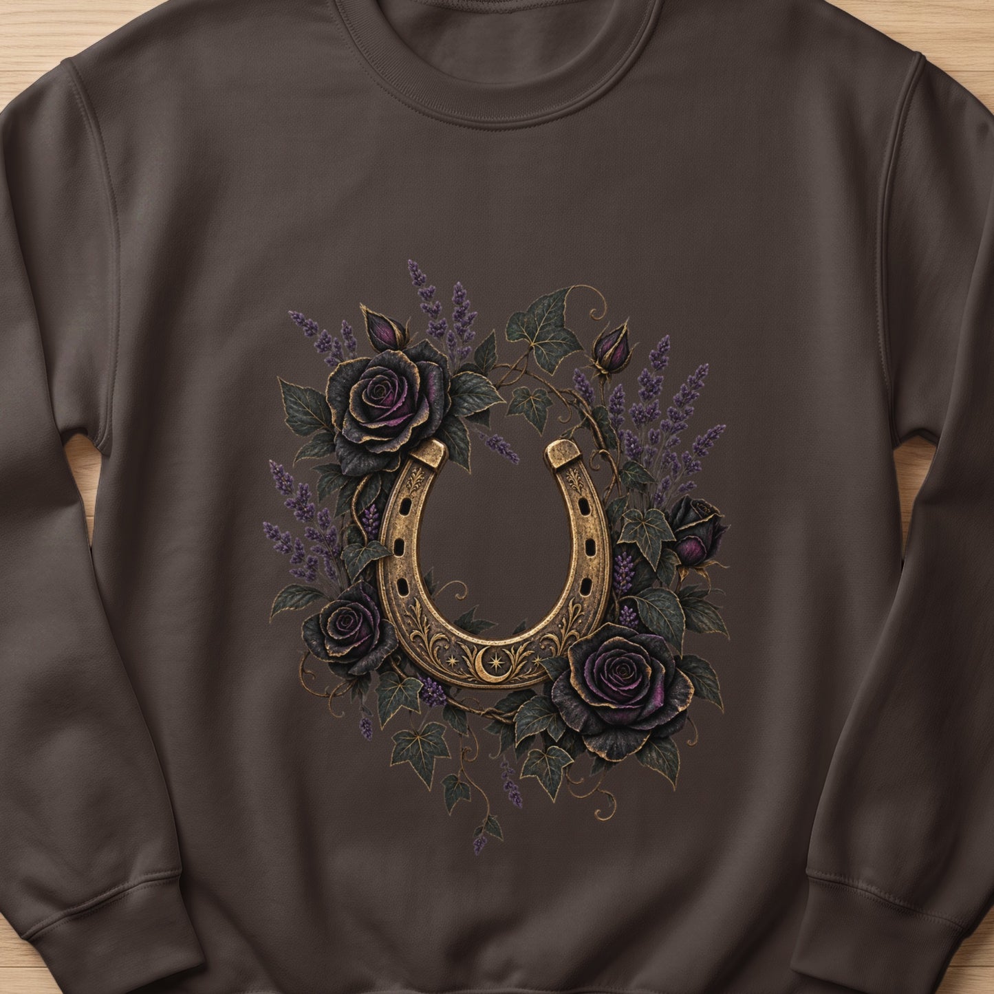 Brown sweatshirt with ornate gold horseshoe surrounded by dark roses and lavender.