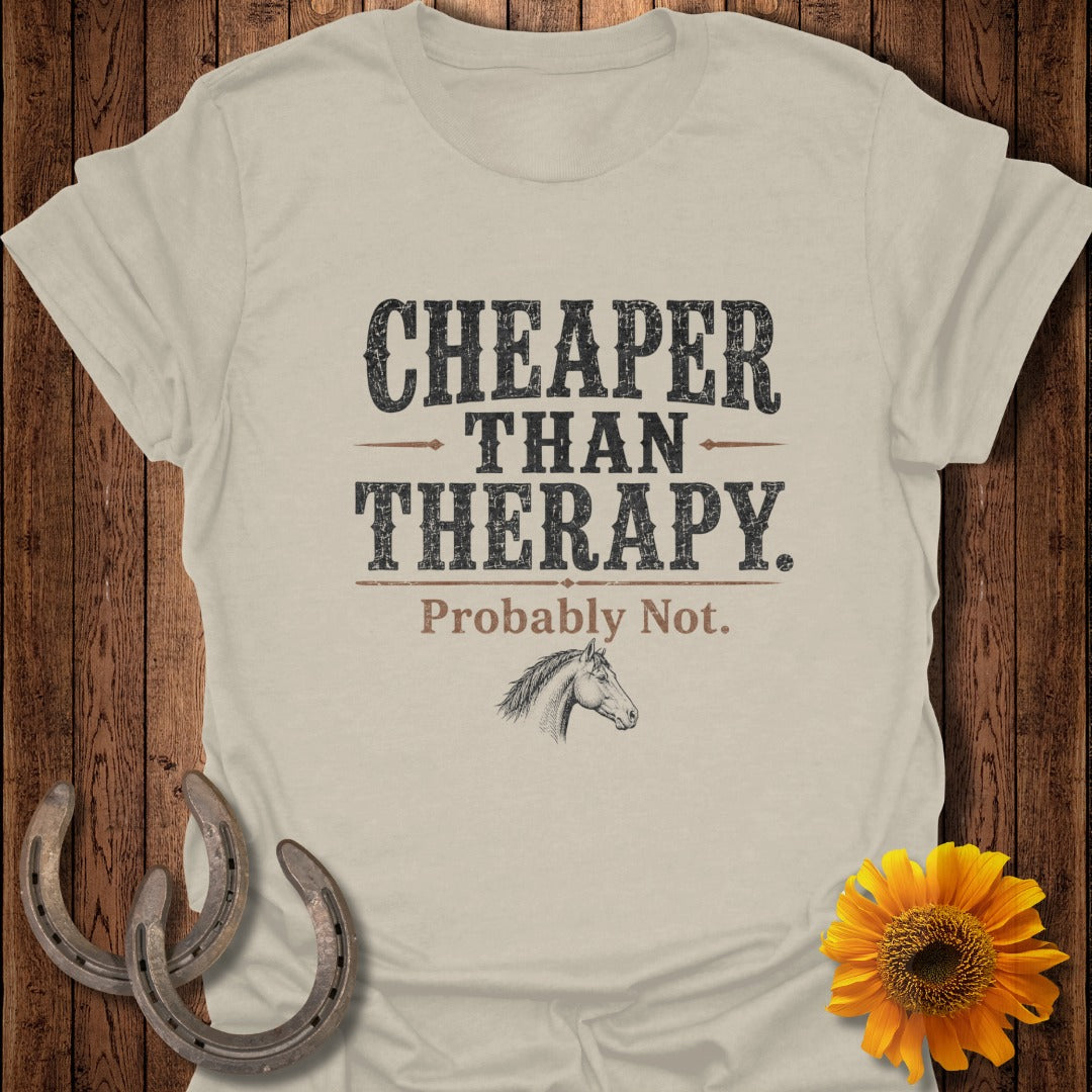 Light tan t-shirt with "Cheaper Than Therapy. Probably Not." and horse illustration.