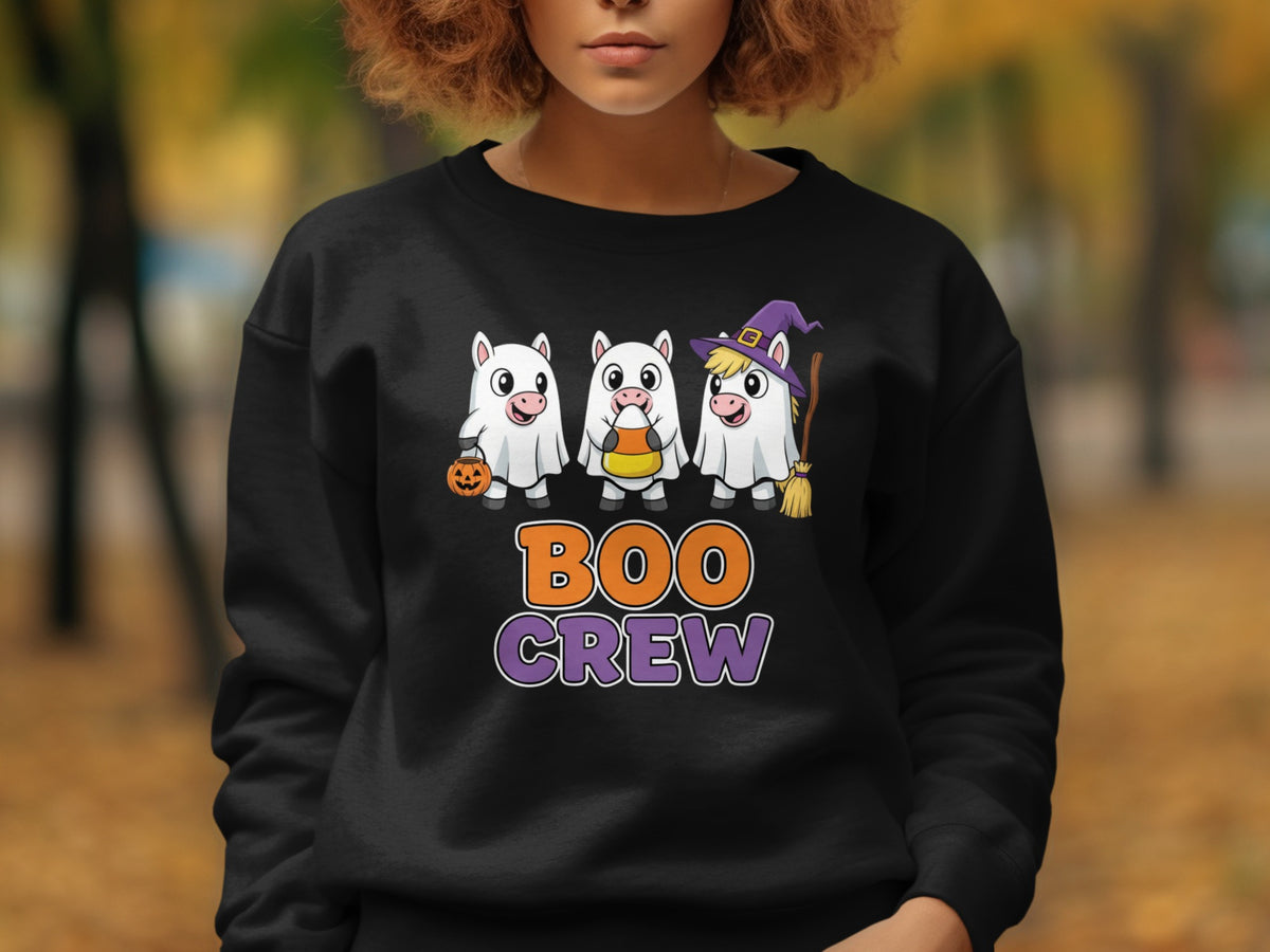 Three white unicorns in ghost costumes holding Halloween treats and a broom with "BOO CREW" text.