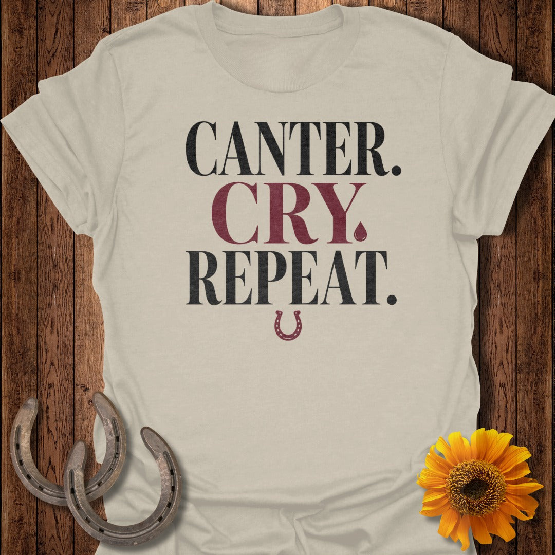 Light beige t-shirt with "CANTER. CRY. REPEAT." text and a horseshoe.