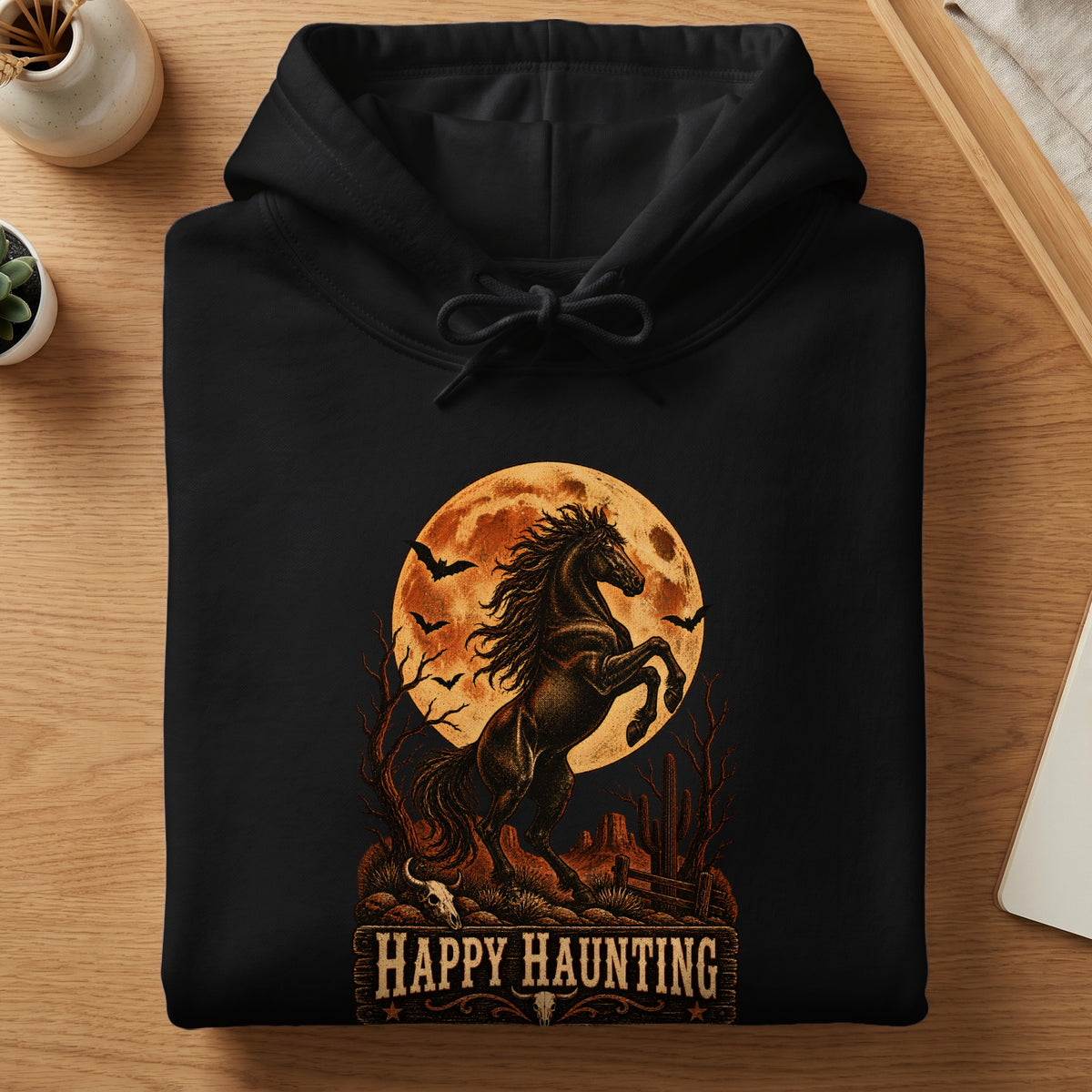 Black hoodie with a rearing horse, bats, and "Happy Haunting" text.
