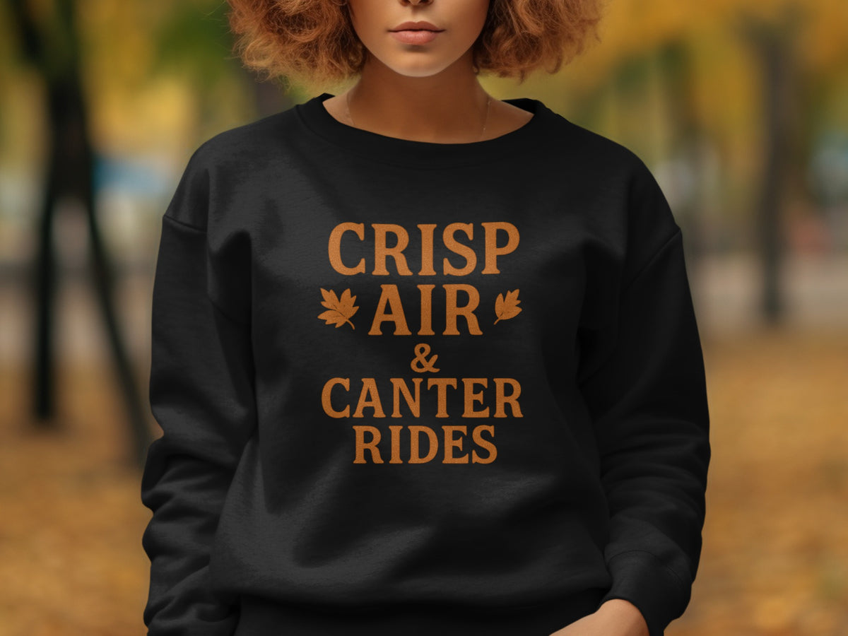 Black sweatshirt with orange text "Crisp Air & Canter Rides" and leaf graphics.