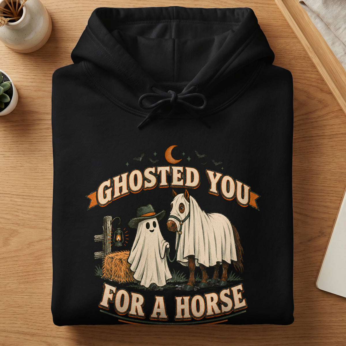 Black hoodie with a ghost and horse graphic that reads "Ghosted You For A Horse".
