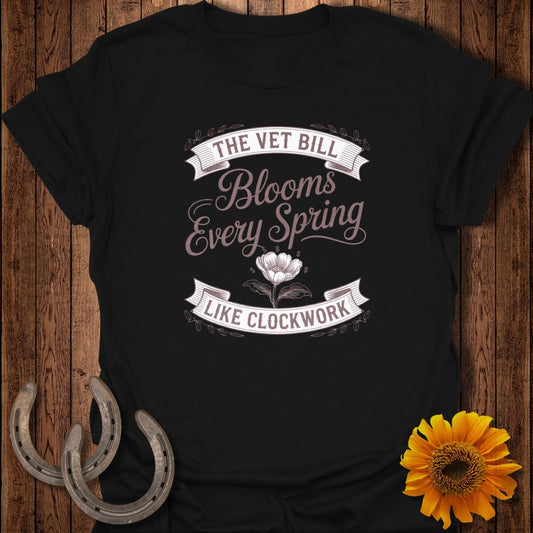 Black t-shirt with "The Vet Bill Blooms Every Spring Like Clockwork" text.