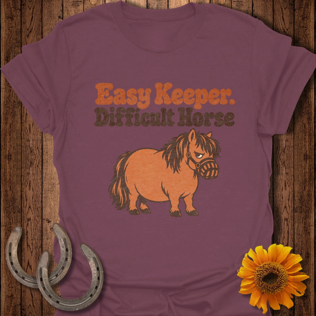 Purple t-shirt with "Easy Keeper. Difficult Horse" text and cartoon pony.