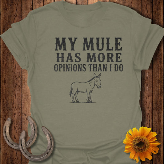 Olive green t-shirt with "MY MULE HAS MORE OPINIONS THAN I DO" text and mule illustration.