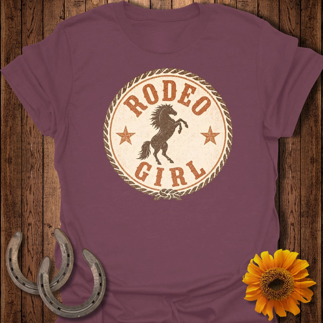 Maroon t-shirt with "Rodeo Girl" text and a bucking horse graphic.