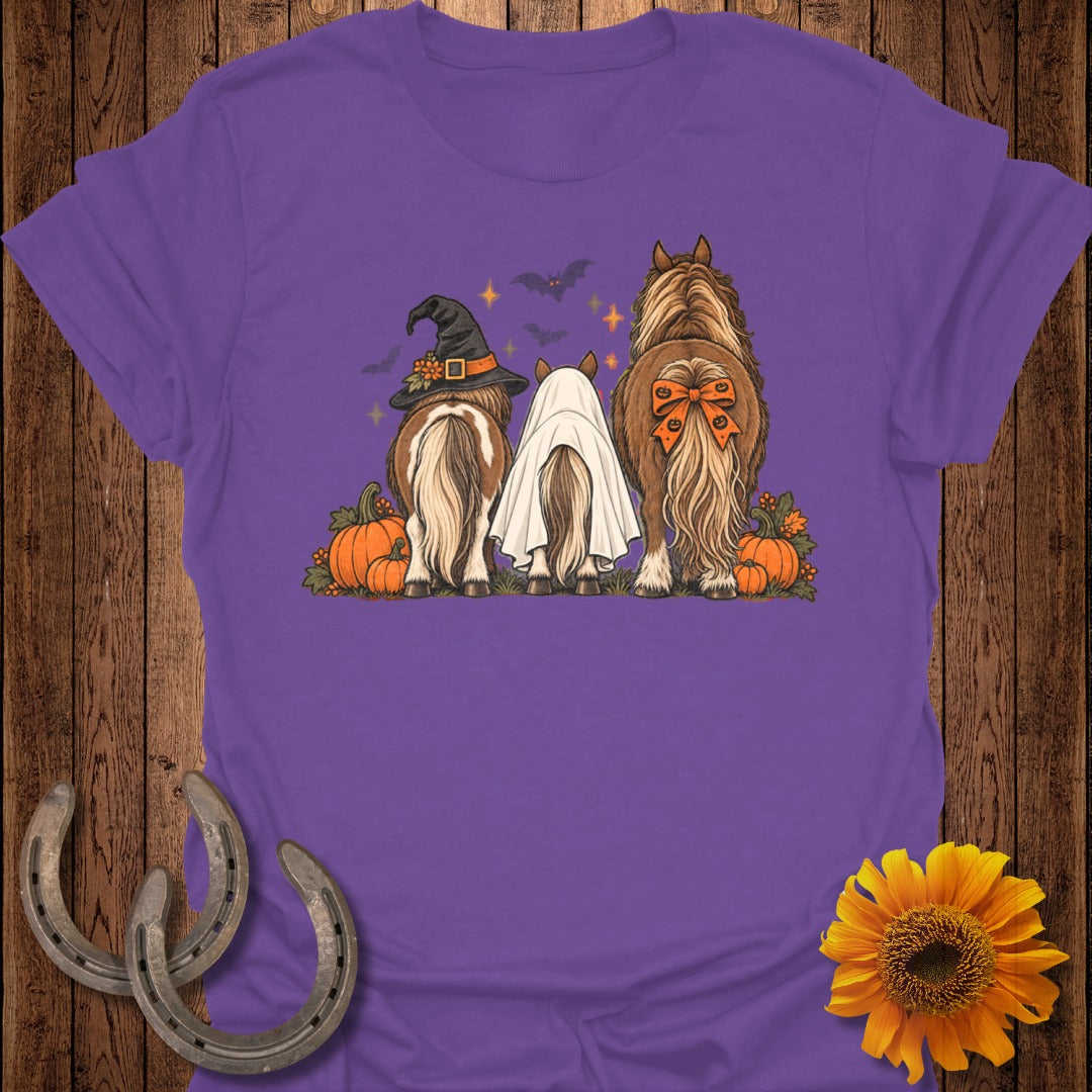 Three horses in Halloween costumes: witch hat, ghost, and pumpkin bow.