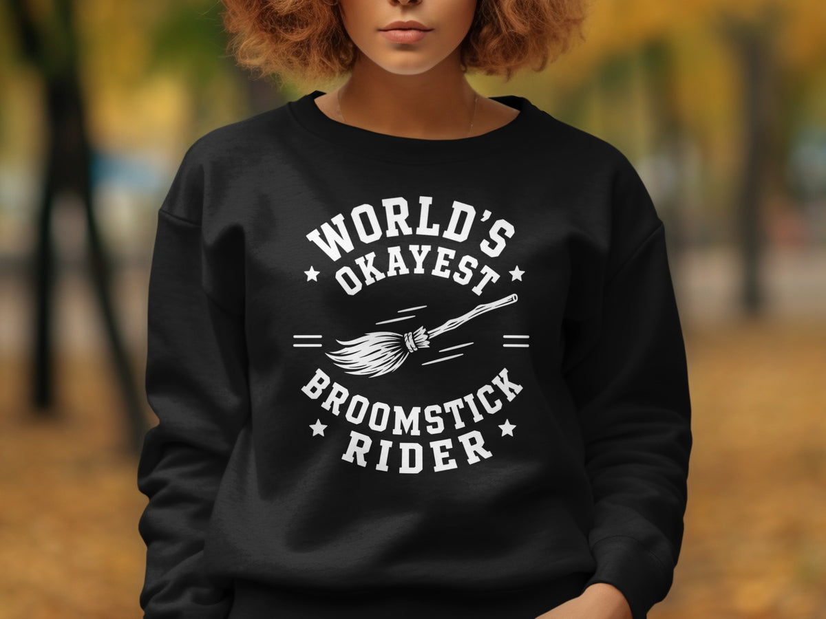 Black sweatshirt with white text that says "World's Okayest Broomstick Rider" and a broom.