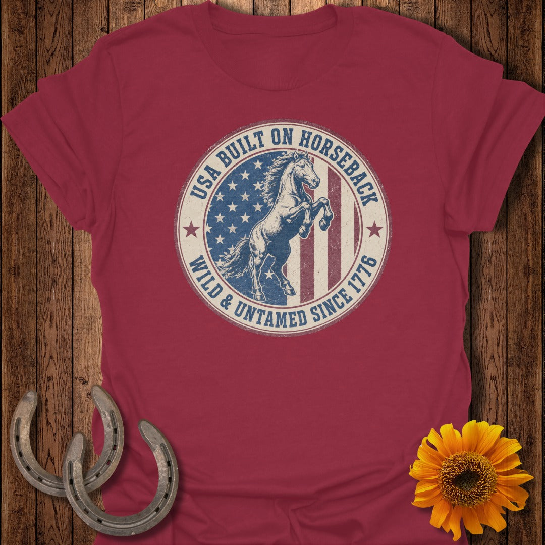 Red t-shirt with "USA Built On Horseback Wild & Untamed Since 1776" circular graphic.