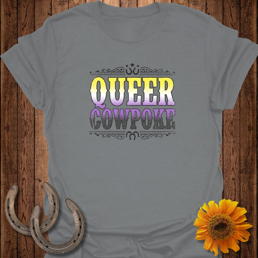 Grey t-shirt with "QUEER COWPOKE" in distressed purple and yellow lettering.