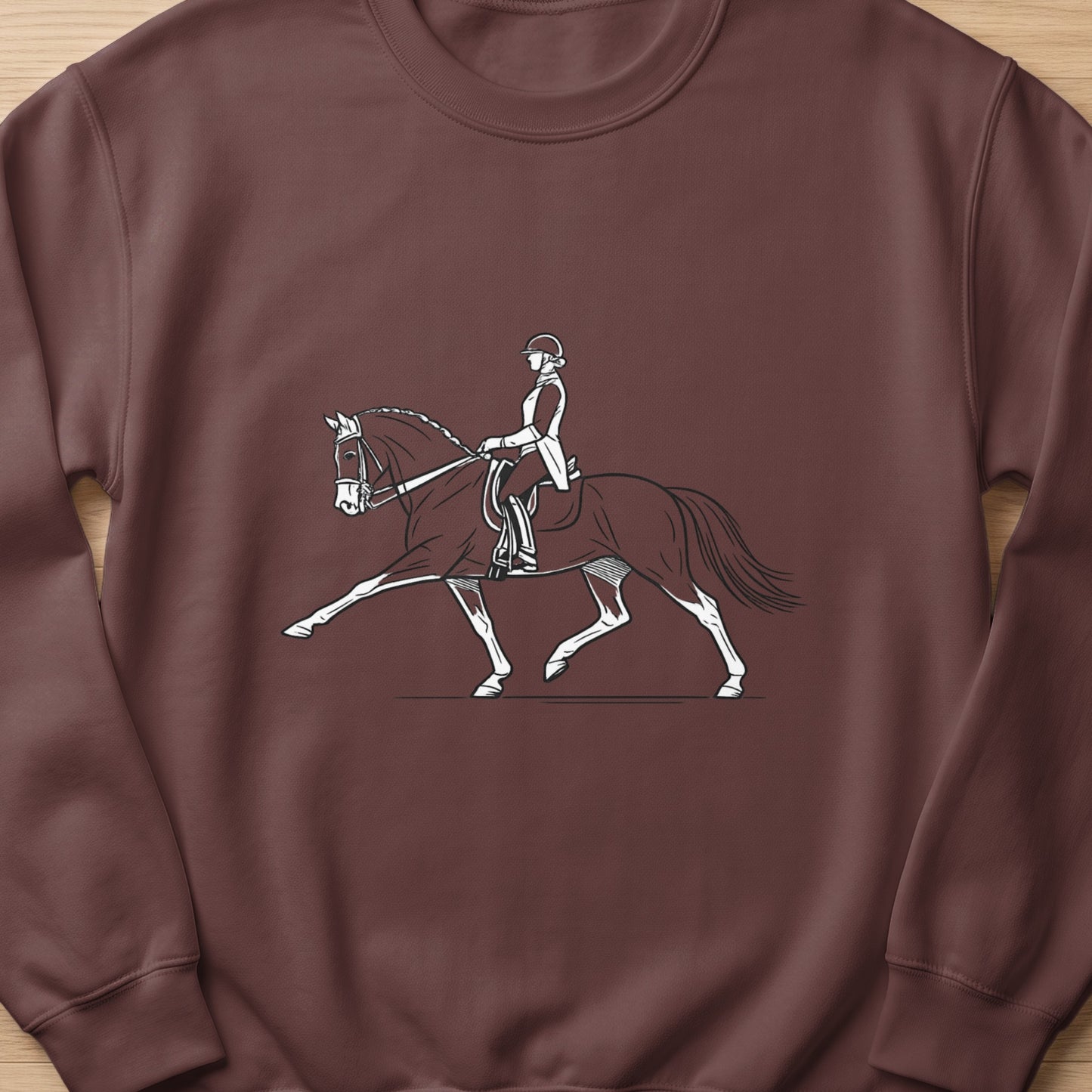 Line art illustration of a person in riding attire on a horse performing a dressage movement.