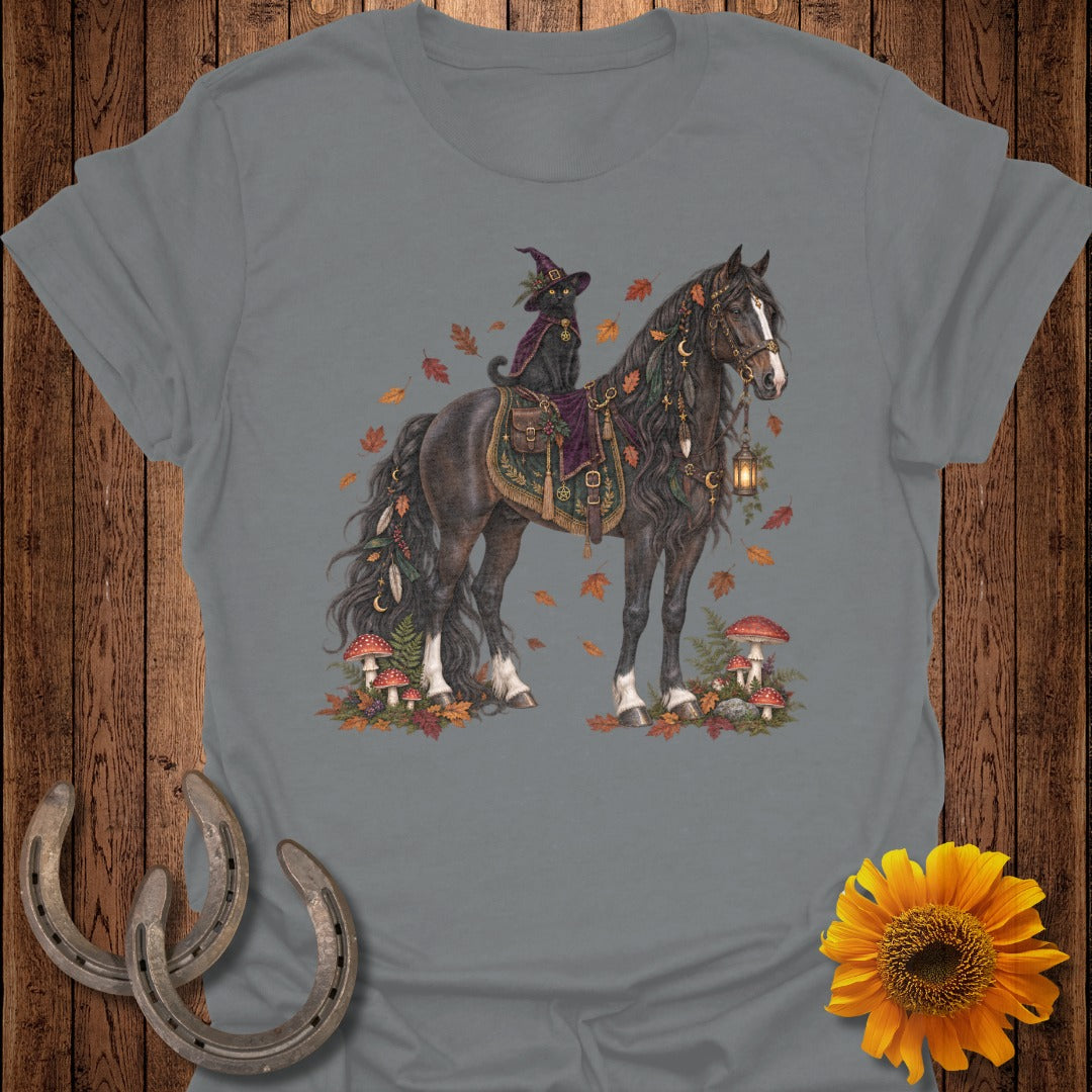 Black cat in witch hat rides a decorated horse amongst autumn leaves and mushrooms.