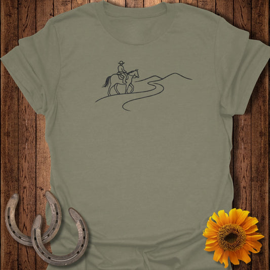 Olive green t-shirt with a black line drawing of a person riding a horse on a winding path.