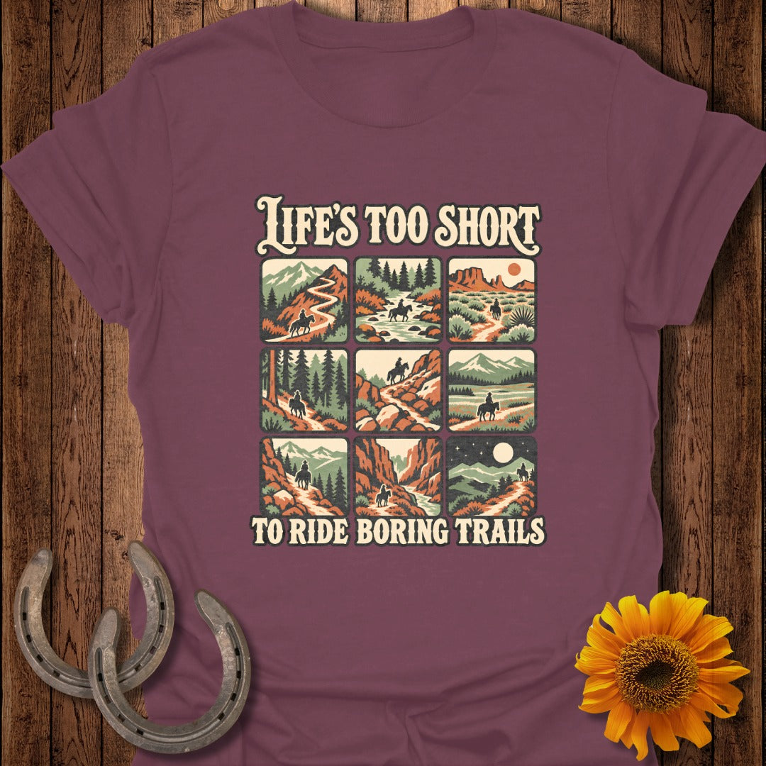 Shirt with "Life's Too Short To Ride Boring Trails" and nine small scenes of horseback riding.