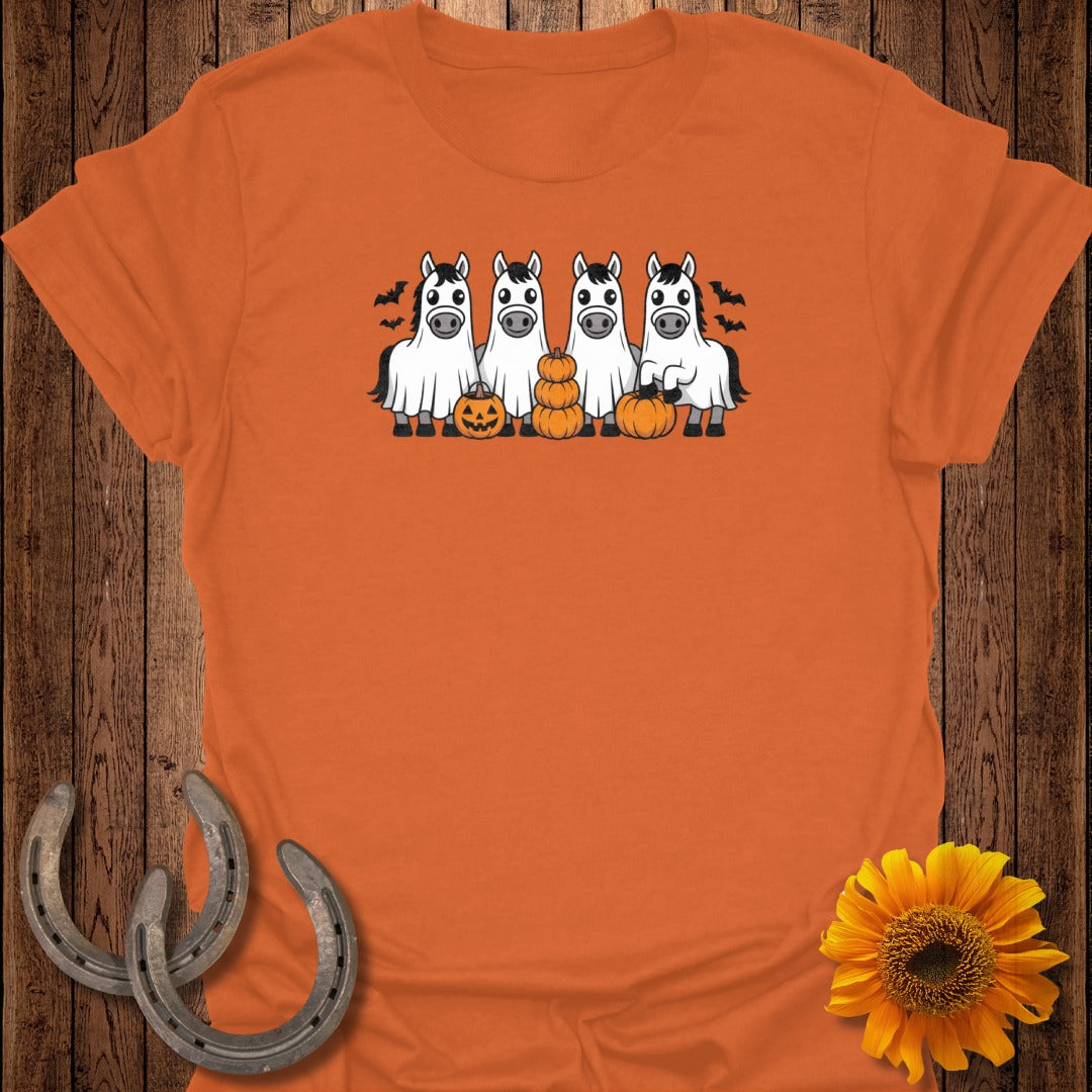 Four horses in ghost costumes stand with pumpkins, surrounded by bats.