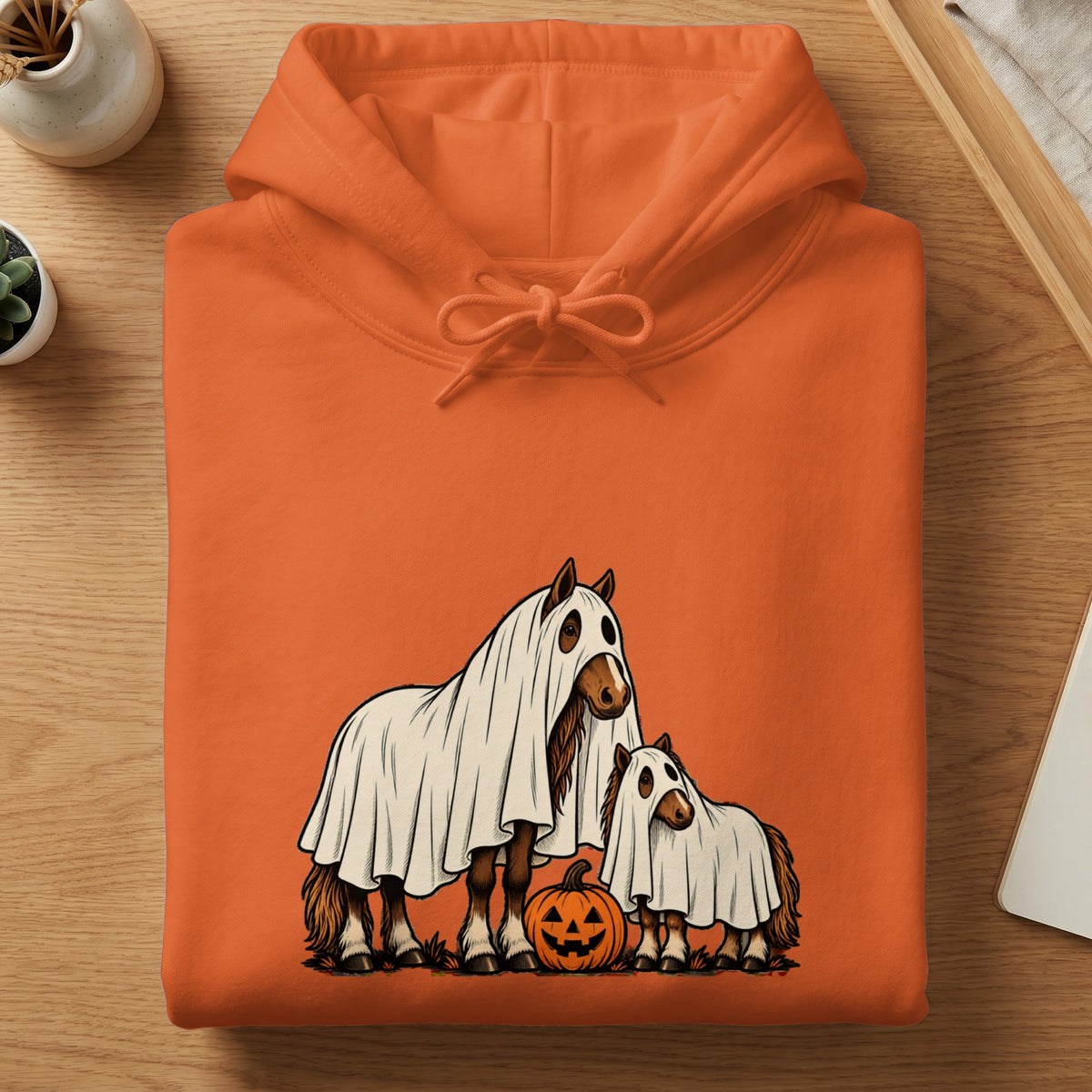 Orange hoodie featuring two horses in ghost costumes and a pumpkin.