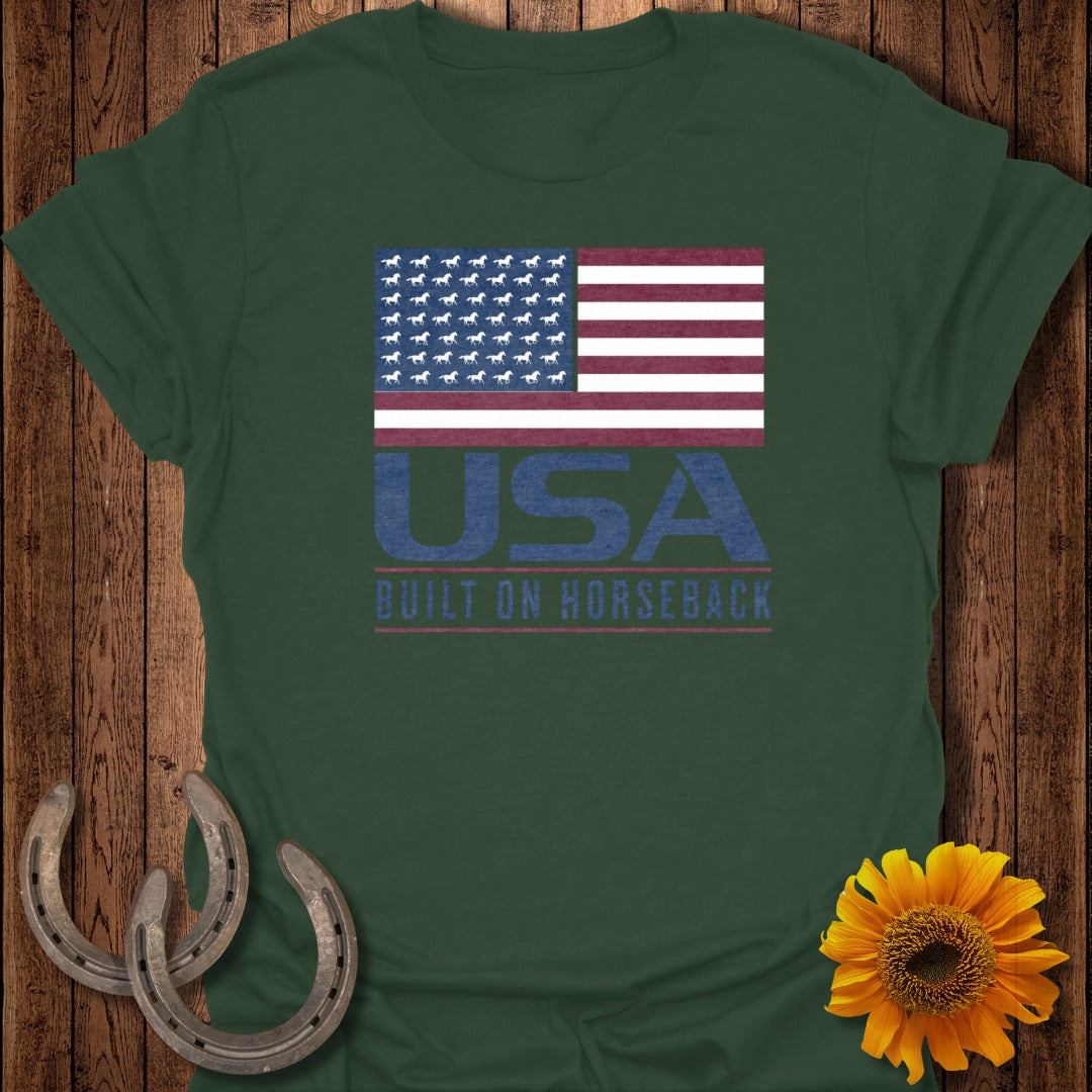 Dark green t-shirt with American flag design made of horses and text "USA Built on Horseback".