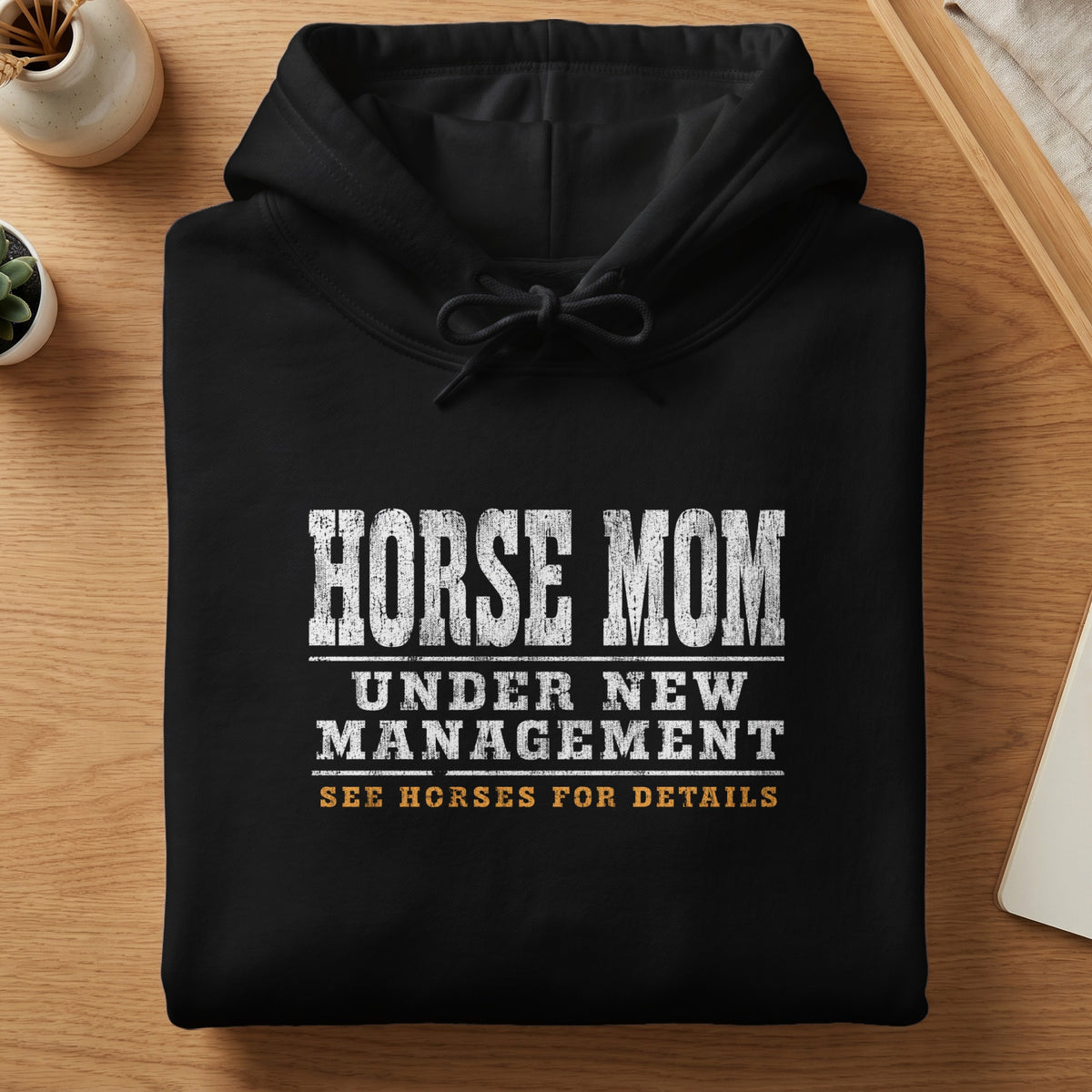 Black hoodie with "HORSE MOM UNDER NEW MANAGEMENT SEE HORSES FOR DETAILS" graphic.