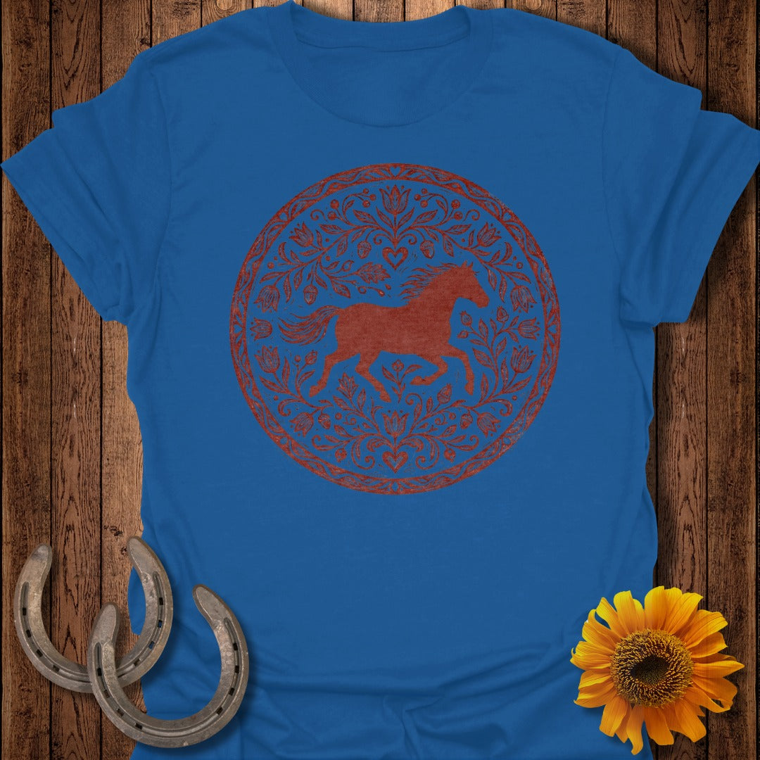 Blue t-shirt with a red circular horse and floral design.