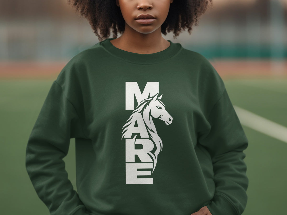 A person wearing a dark green crewneck sweatshirt with the white text MARE incorporating a horse illustration.