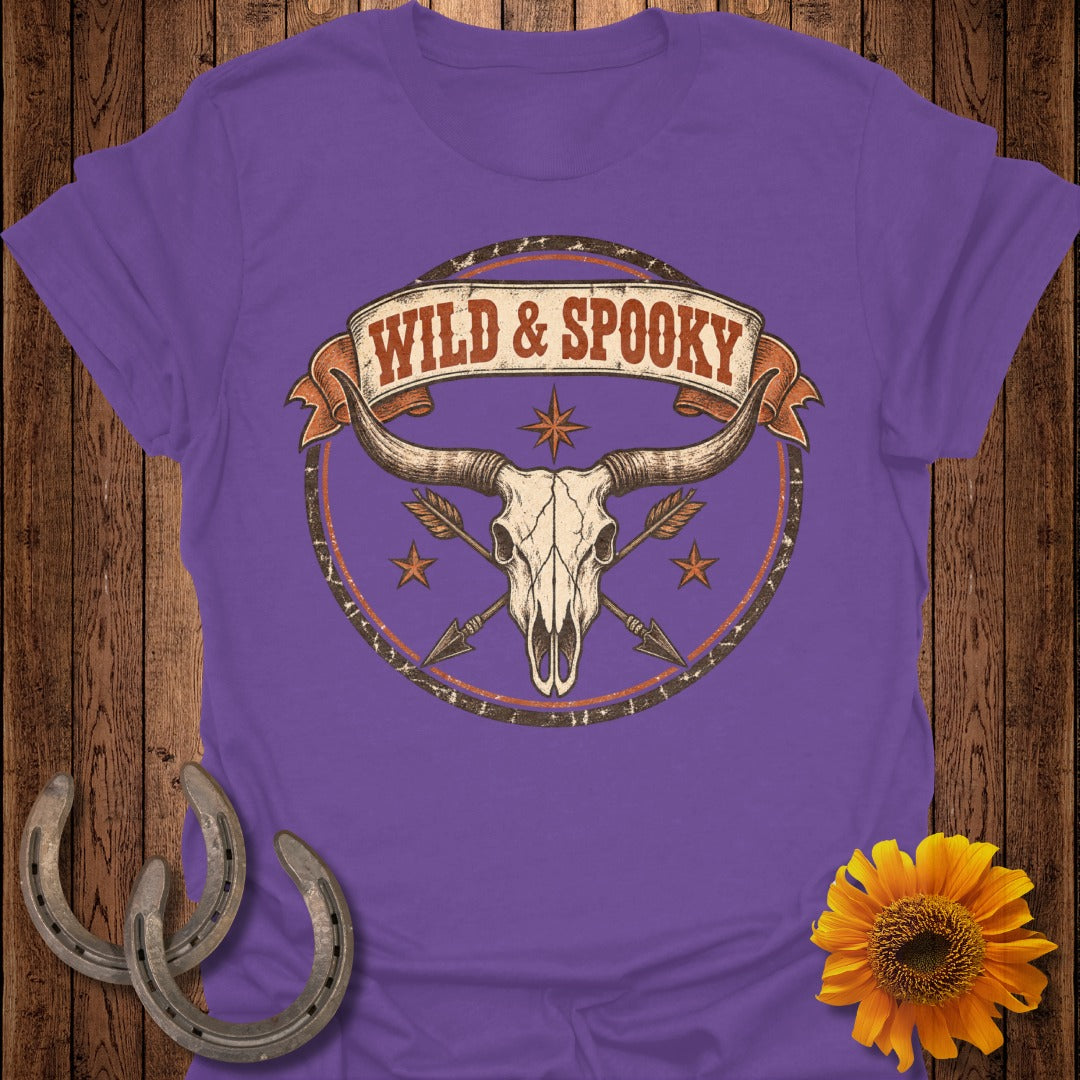 Purple t-shirt with a longhorn skull, arrows, and text "WILD & SPOOKY".