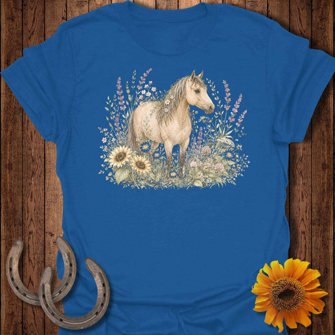 Light tan horse standing in a field of wildflowers and sunflowers.