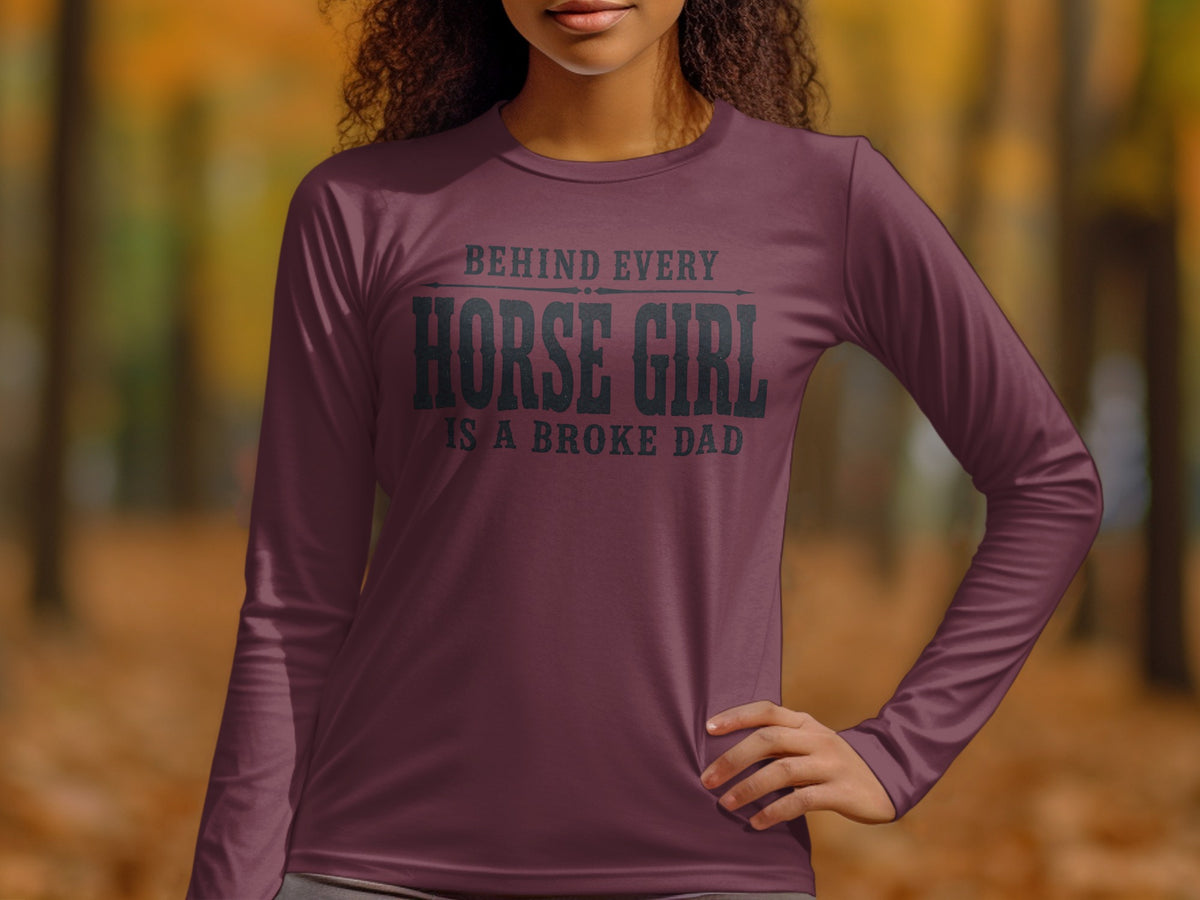 Maroon long-sleeve shirt with "Behind Every Horse Girl Is A Broke Dad" text.