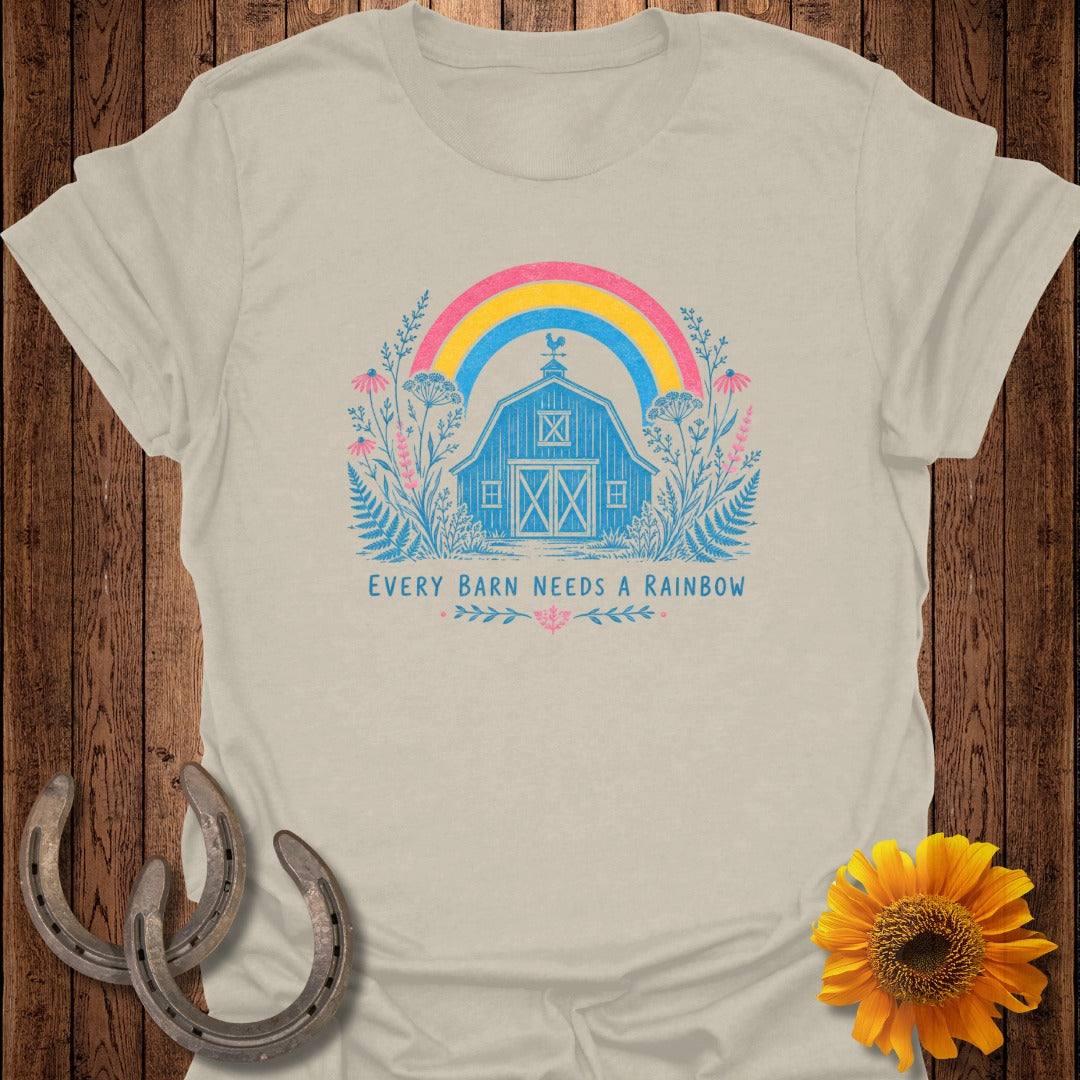 Barn with rainbow and floral accents, text reads "Every Barn Needs a Rainbow."