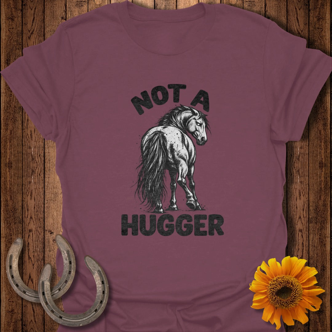 Maroon t-shirt featuring a black graphic of a horse looking back, with text reading NOT A HUGGER.