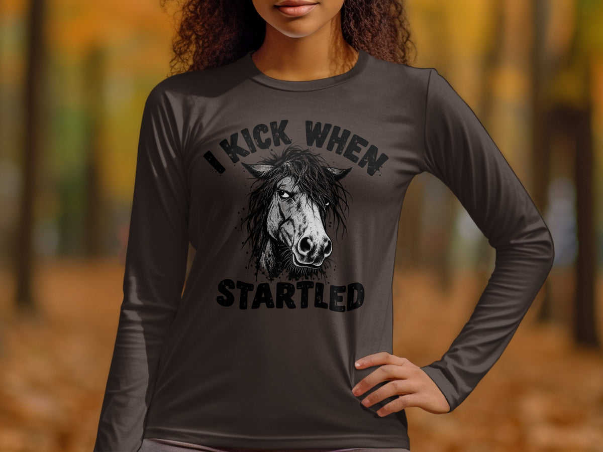 Dark long sleeve shirt with distressed graphic of a horse and text "I Kick When Startled".