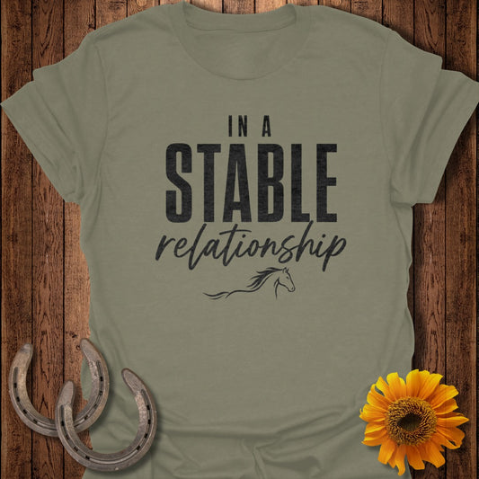 Olive green t-shirt with "IN A STABLE relationship" text and a horse silhouette.