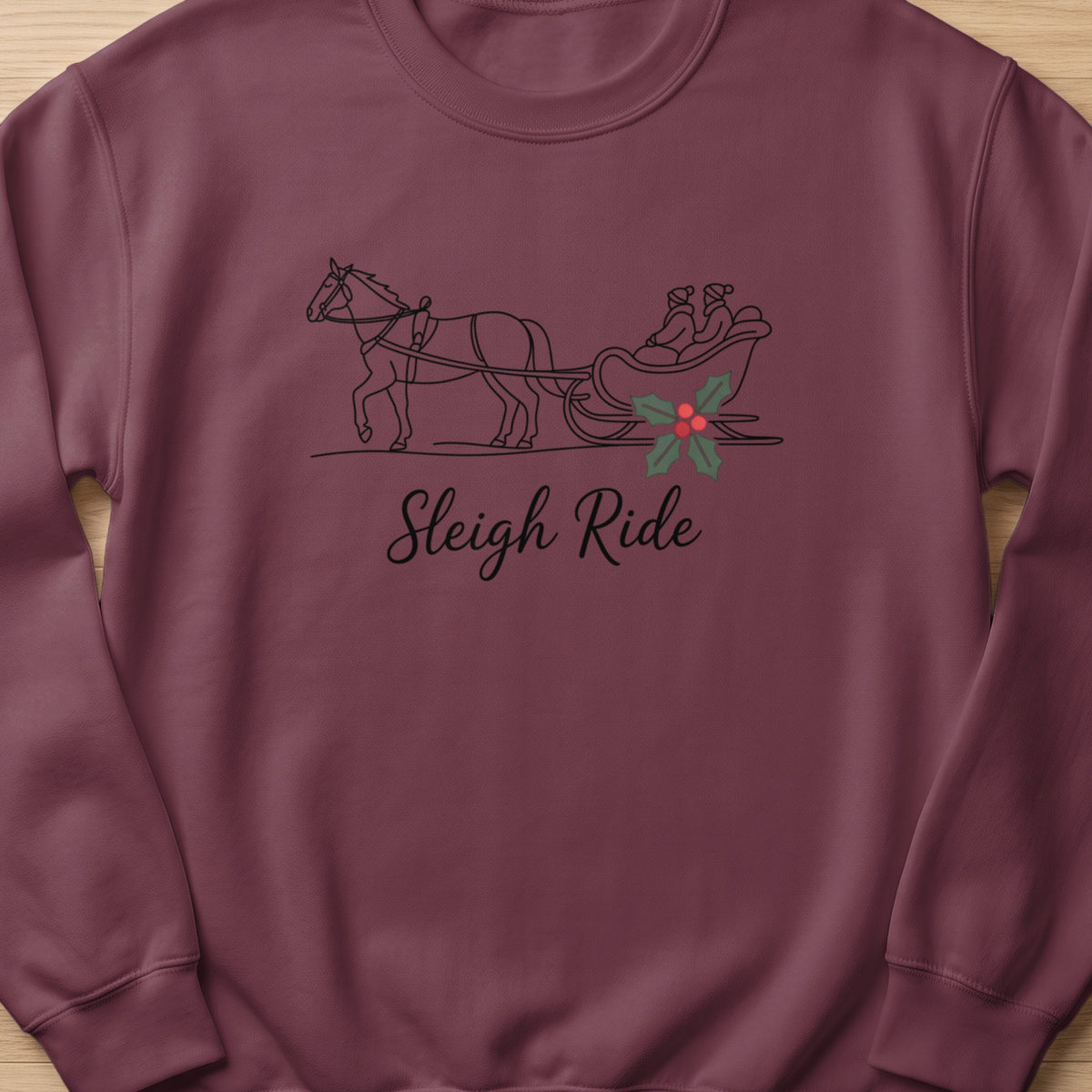 Burgundy sweatshirt with a line-drawing of a horse-drawn sleigh and "Sleigh Ride" text.