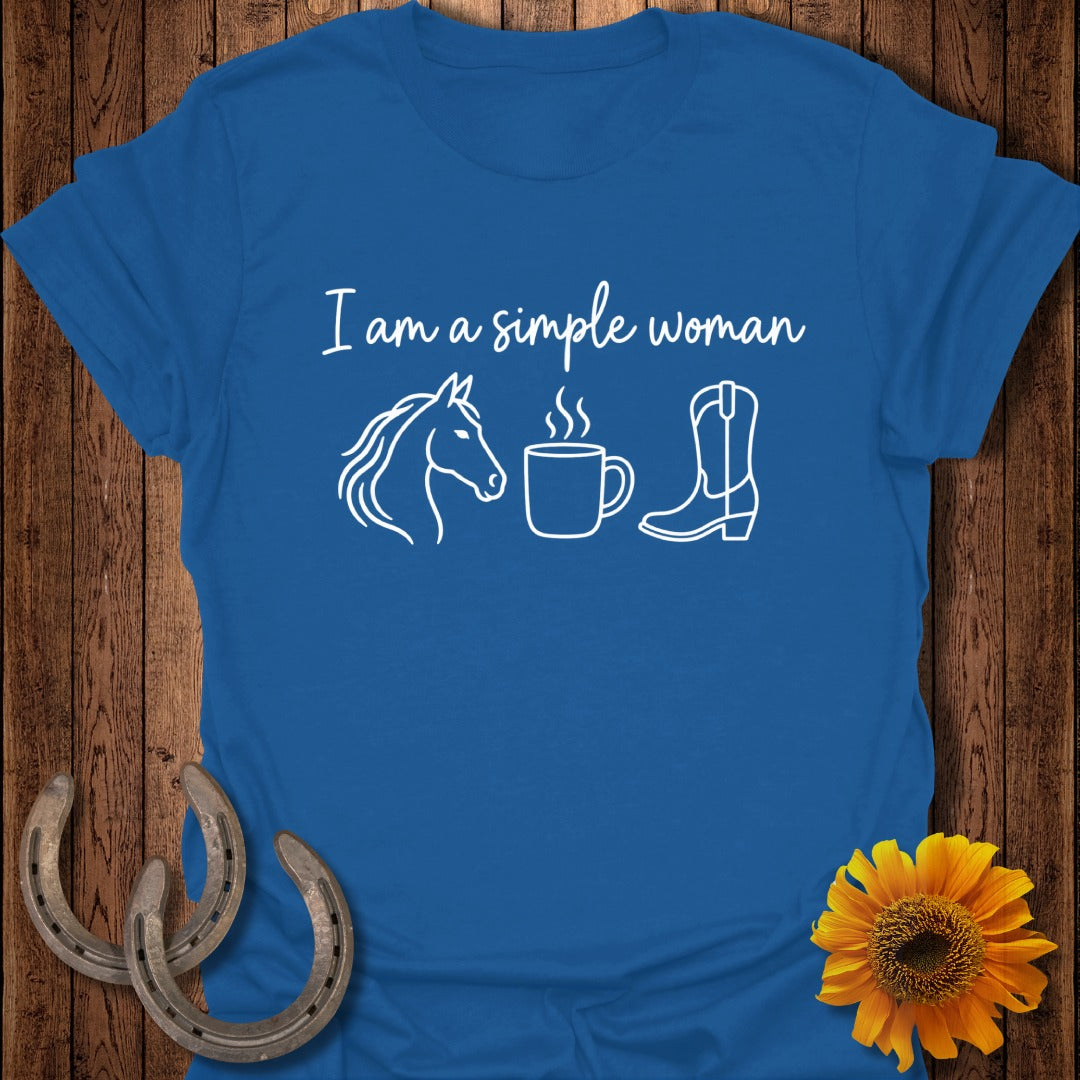 A blue t-shirt printed with the text "I am a simple woman" alongside outlines of a horse's head, a coffee cup, and a cowboy boot.