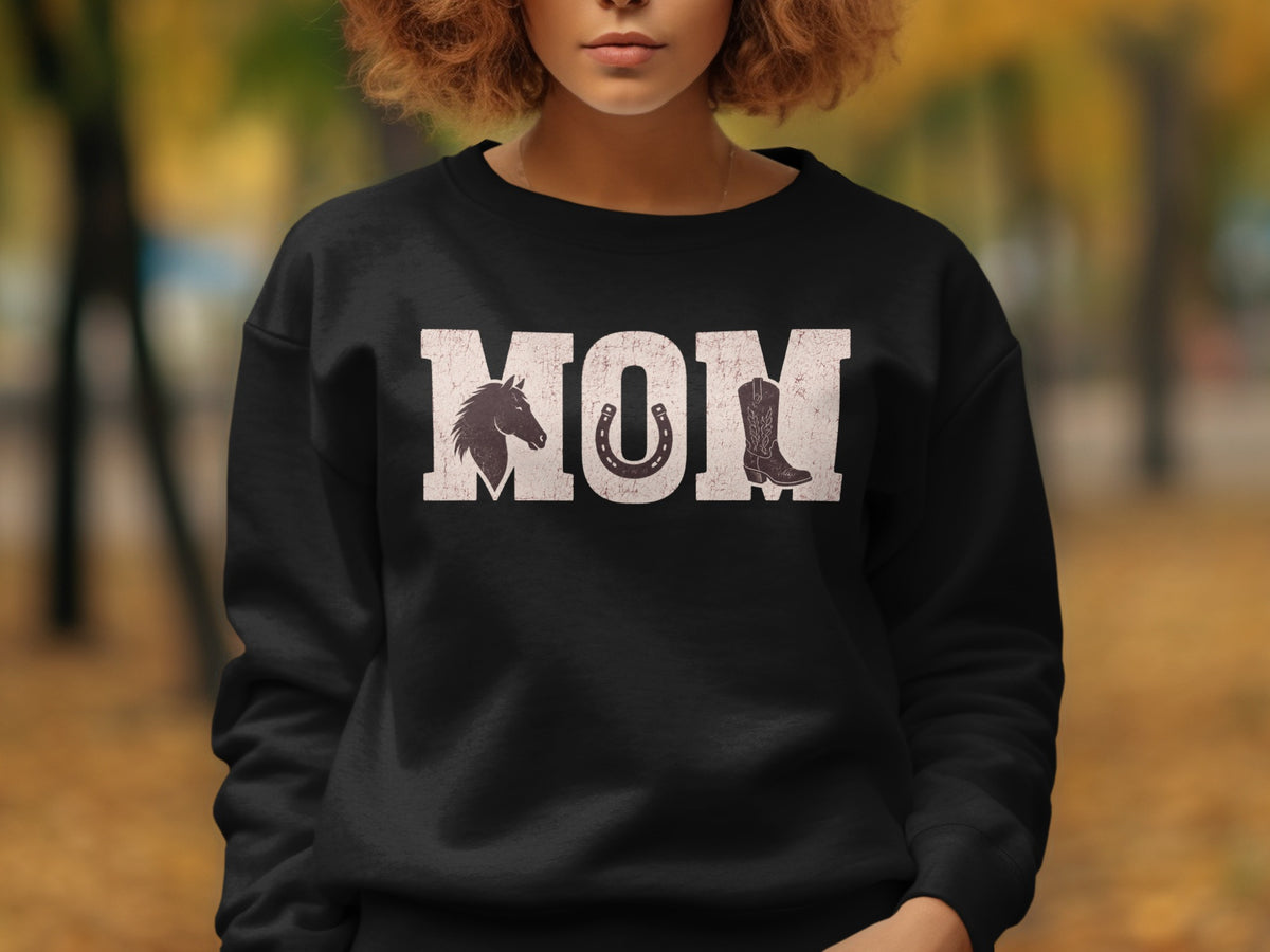 Black sweatshirt with "MOM" graphic featuring horse, horseshoe, and cowboy boot.