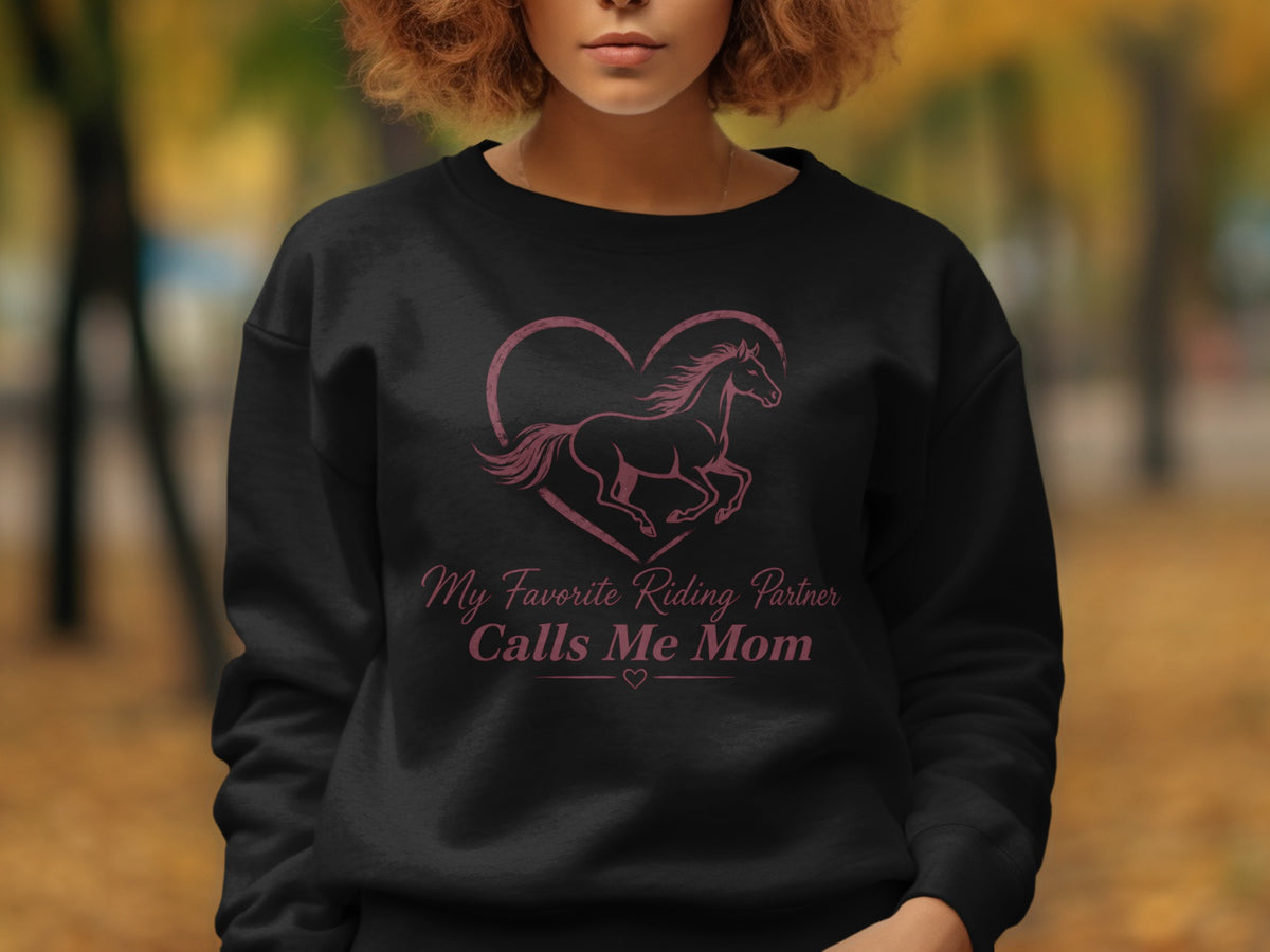 Black sweatshirt with a heart, horse graphic, and text "My Favorite Riding Partner Calls Me Mom".