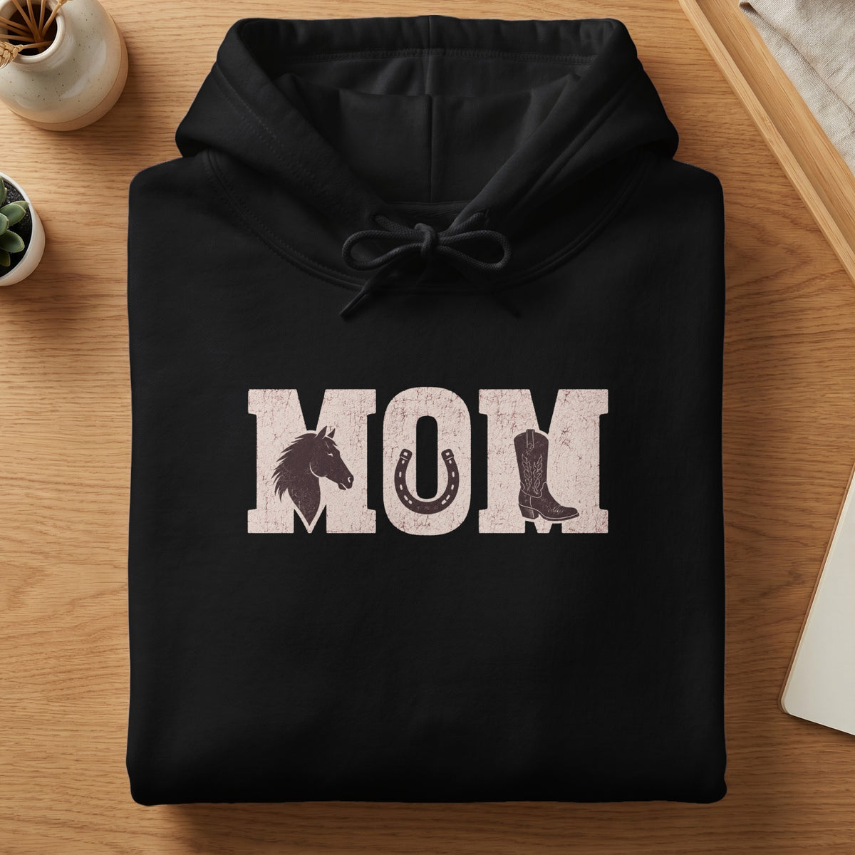 Black hoodie with "MOM" text featuring horse head, horseshoe, and cowboy boot graphics.
