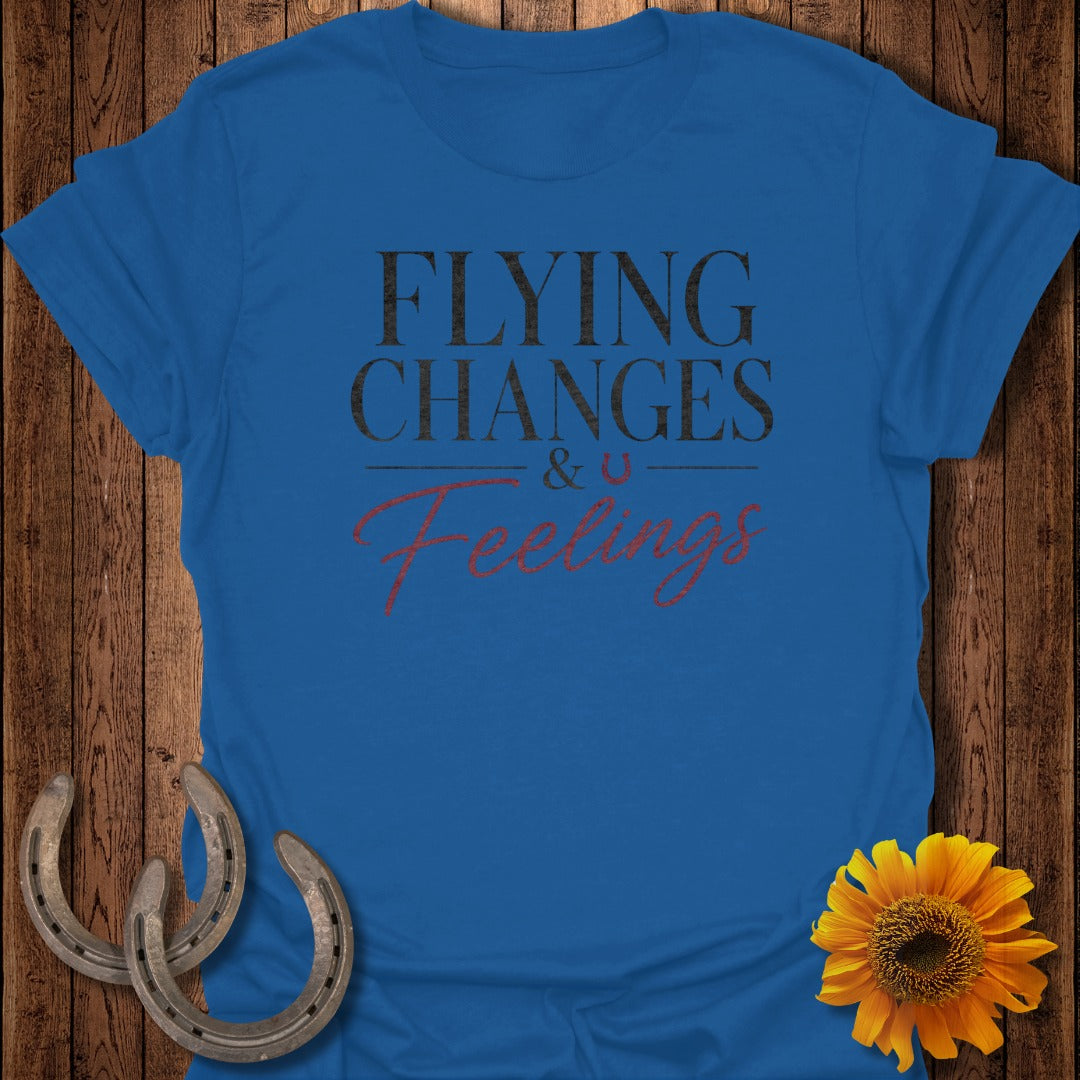 Royal blue t-shirt with "Flying Changes & U Feelings" text, horseshoes, and a sunflower.