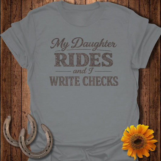 Gray t-shirt with "My Daughter Rides and I Write Checks" text, horseshoes, and sunflower.