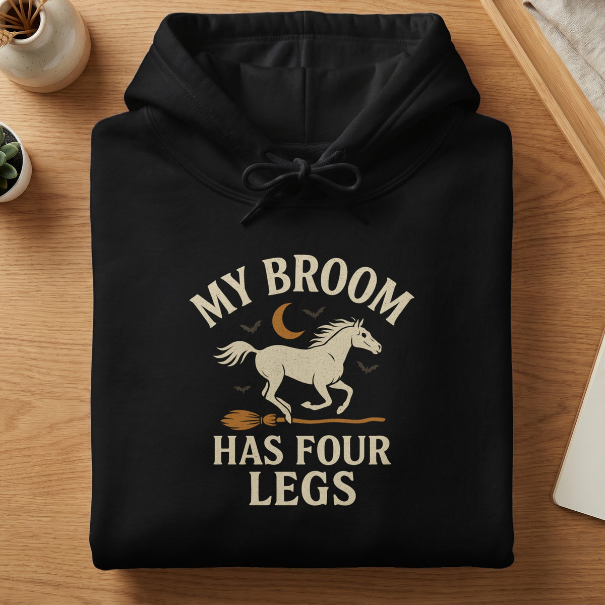 Black hoodie with "My Broom Has Four Legs" text and a horse on a broom graphic.